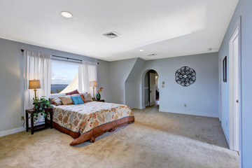 Spacious bedroom interior in light blue color