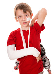 boy with a broken arm holding roller skates