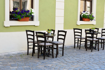 Fototapeta na wymiar Outdoor street cafe tables and chairs