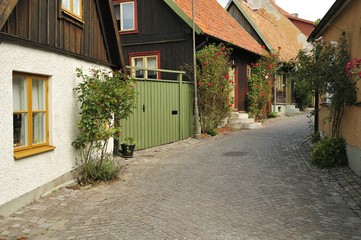 Fototapeta na wymiar Street with old houses in a Swedish town Visby