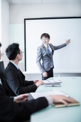 businessman giving a presentation to his colleagues