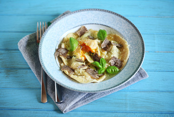 Ravioli with egg yolk and ricotta, with shaved black truffle