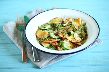 Cucumber and peach salad with elderflower flower, chili