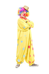 Funny male clown in a yellow costume