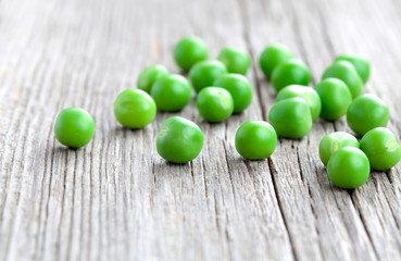 Green peas on wooden background