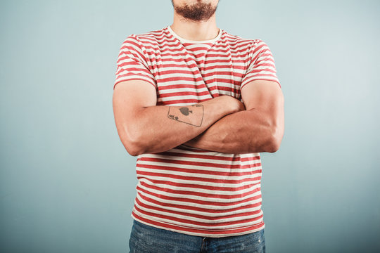 Man in striped shirt with arms crossed