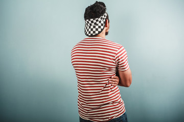 Young man in striped shirt and checkered hat