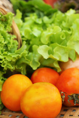 Fototapeta na wymiar Vegetables salad and tomato in the basket