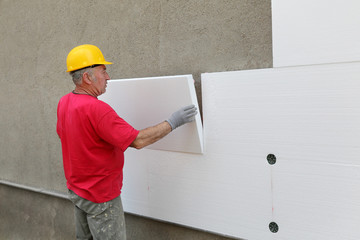 Styrofoam, polystyrene thermal insulation of house wall install - obrazy, fototapety, plakaty