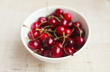 Fresh red cherries in bowl