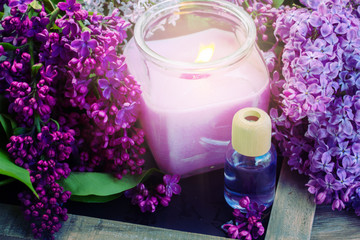 Obraz na płótnie Canvas fresh lilac flowers spa setting with candle