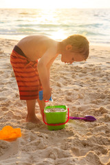 child playing on sunset beach