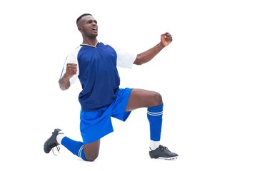 Obraz na płótnie Canvas Football player in blue celebrating a win