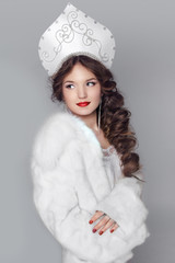 Fashion girl in fur coat and exclusive design clothes on manners