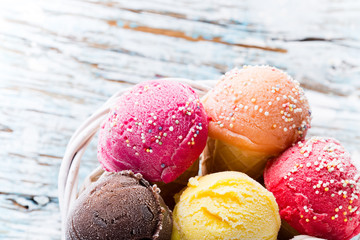 Ice cream scoops on wooden table.