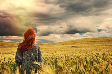 fashion young red hair woman standing back outdoor on breathtaki
