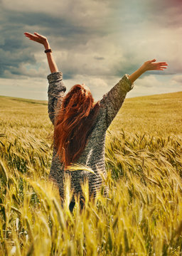 Young Red Hair Woman Standing Back Hands Up To Breathtaking View