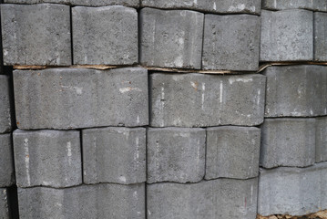 Stack of gray pavement cement bricks