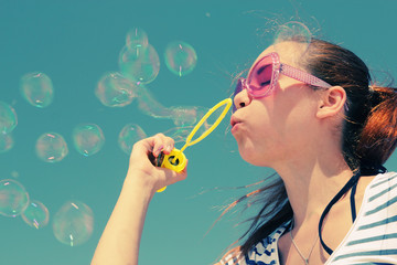 pretty girl blowing bubbles