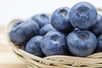 Macro shot of fresh ripe blueberries in wicker basket