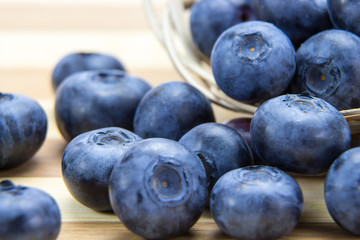 Macro shot of fresh ripe blueberries in wicker basket