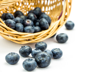 Macro shot of fresh ripe blueberries in wicker basket