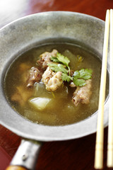 chinese chicken and vegetable soup in metal bowl