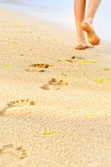 Fototapeta na wymiar Beautiful woman legs, walking on the beach