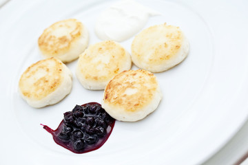 sweet cheese pancakes on a plate on a white background