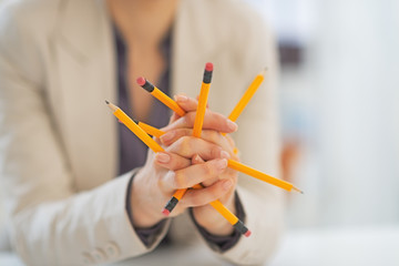 Closeup on business woman playing with pencils