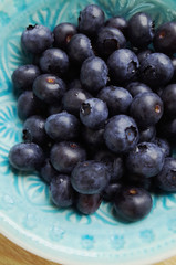 Freshly washed blueberries in a blue bowl