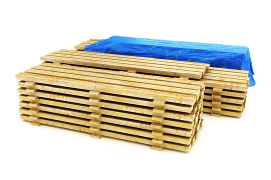 Stacks of wood building lumber on a white background.