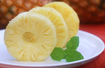 Sliced pineapple with mint leaves