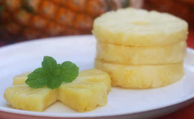 Sliced pineapple with mint leaves
