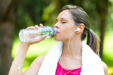 Active woman drinking water