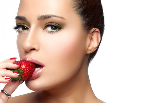 Beautiful Young Woman Eating Strawberry