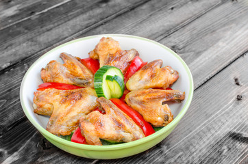 Chicken wings baked with vegetable