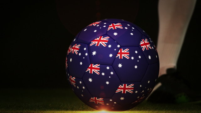 Football player kicking australia flag ball