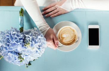 Bride drinking coffee at a wedding day
