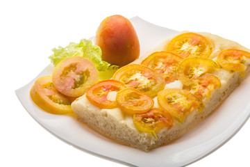 Pizza with sliced tomato