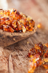 Gum arabic, also known as acacia gum - in  old wooden spoon
