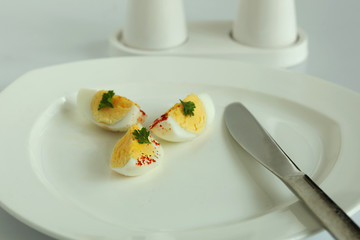 Hard boiled egg slices in white plate