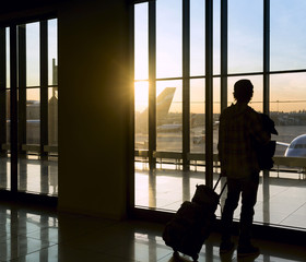 Fototapeta na wymiar Silhouette of man near window in airport