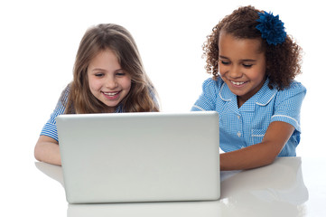 Obraz na płótnie Canvas Cute little school girls with laptop