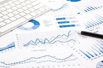 blue graph and chart reports on office table - obrazy, fototapety, plakaty