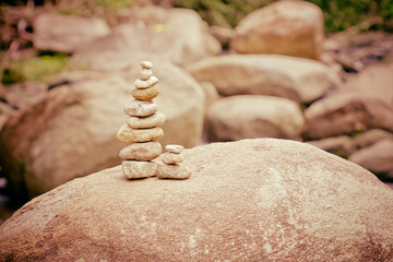 Fototapeta na wymiar stone made tower on river. balance in nature
