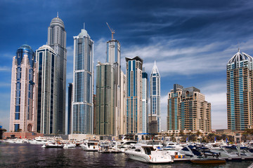 Fototapeta na wymiar Dubai Marina with boat against skyscrapers in Dubai, UAE