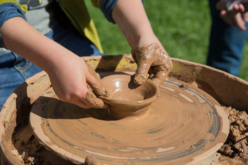 First lesson of pottery using  wheel