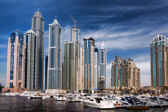 Dubai Marina with boat against skyscrapers in Dubai, UAE