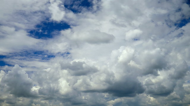 White clouds running over blue sky. Timelapse